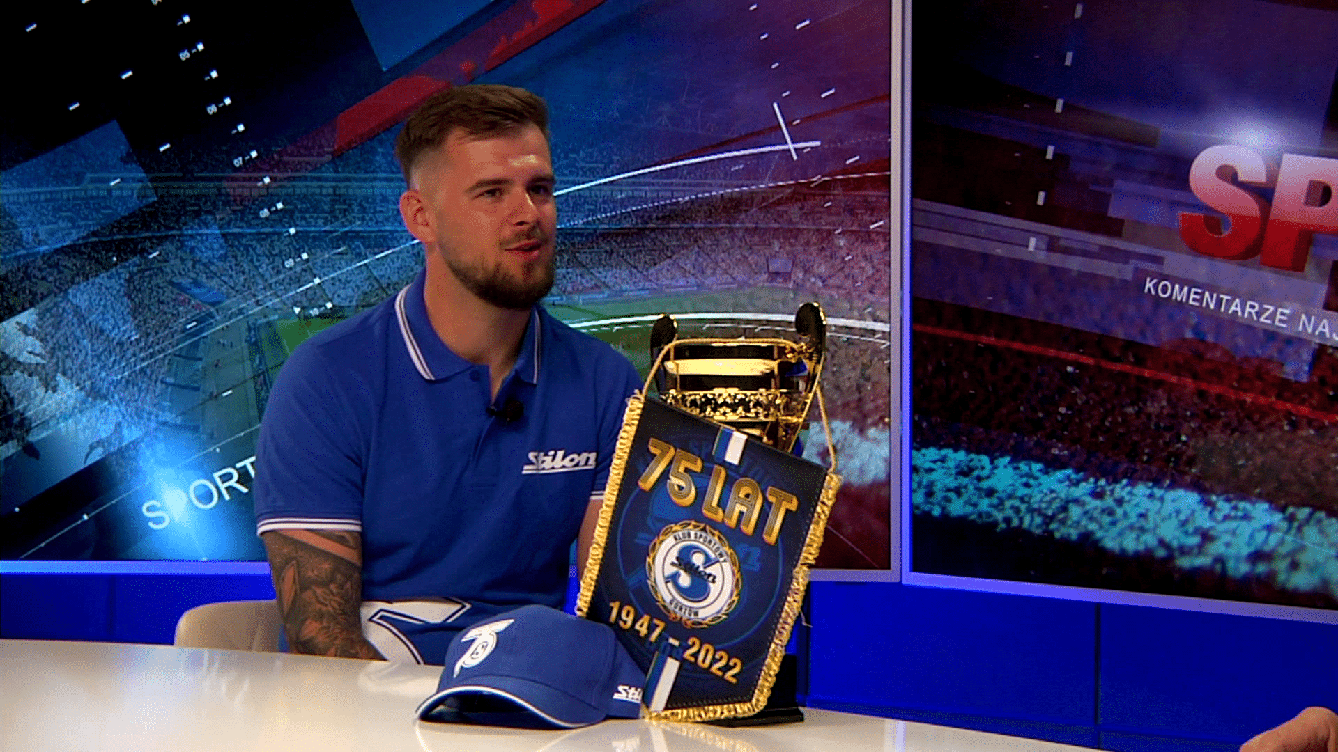 Młody mężczyzna przed nim puchar proporczyk i czapeczka  Karol Gliwiński trener Stilonu Gorzów Moje pierwsze marzenie już się spełniło WIDEO