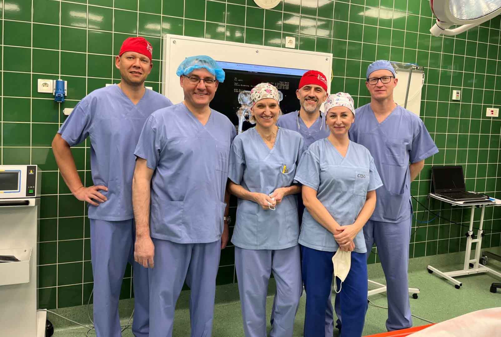 336168562_544685601083138_3359409618638259841_n Sześć uśmiechniętych osób w medycznych fartuchach i czepkach Biodro uratowane Dzięki protezie wykonanej w technologii 3D wartej majątek