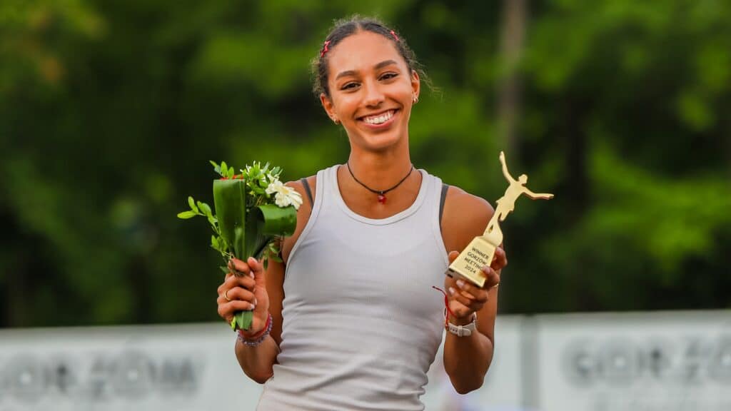 Uśmiechnięta kobieta z bukietem kwiatów i statuetką