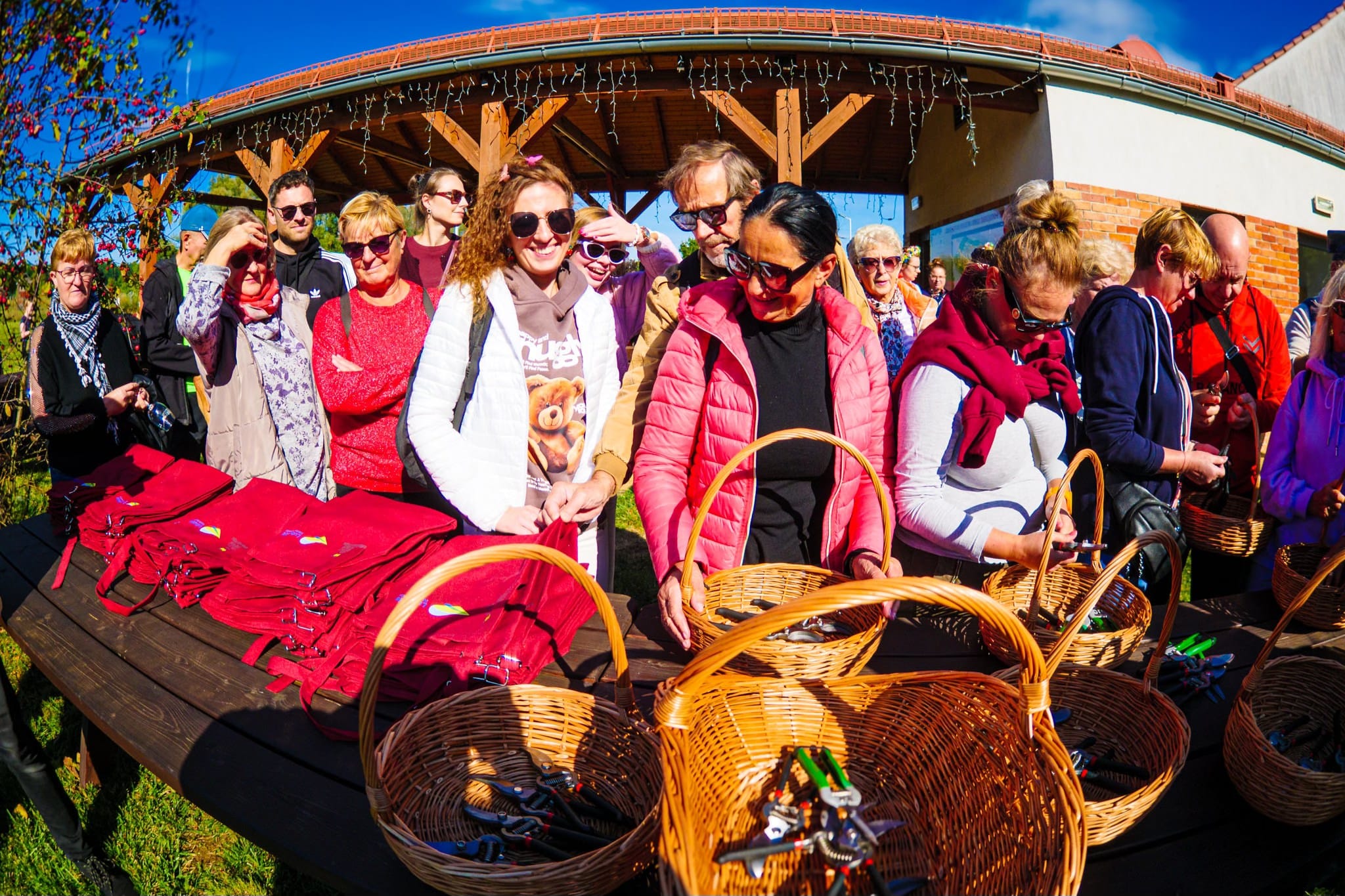 ludzie otrzymujący narzędzia  Pierwsze winne grona zebrane